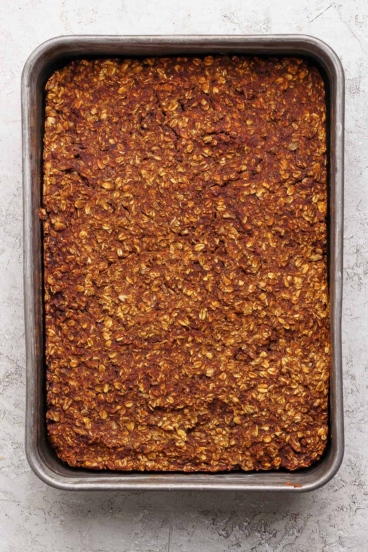 A metal pan of pumpkin baked oatmeal after baking.