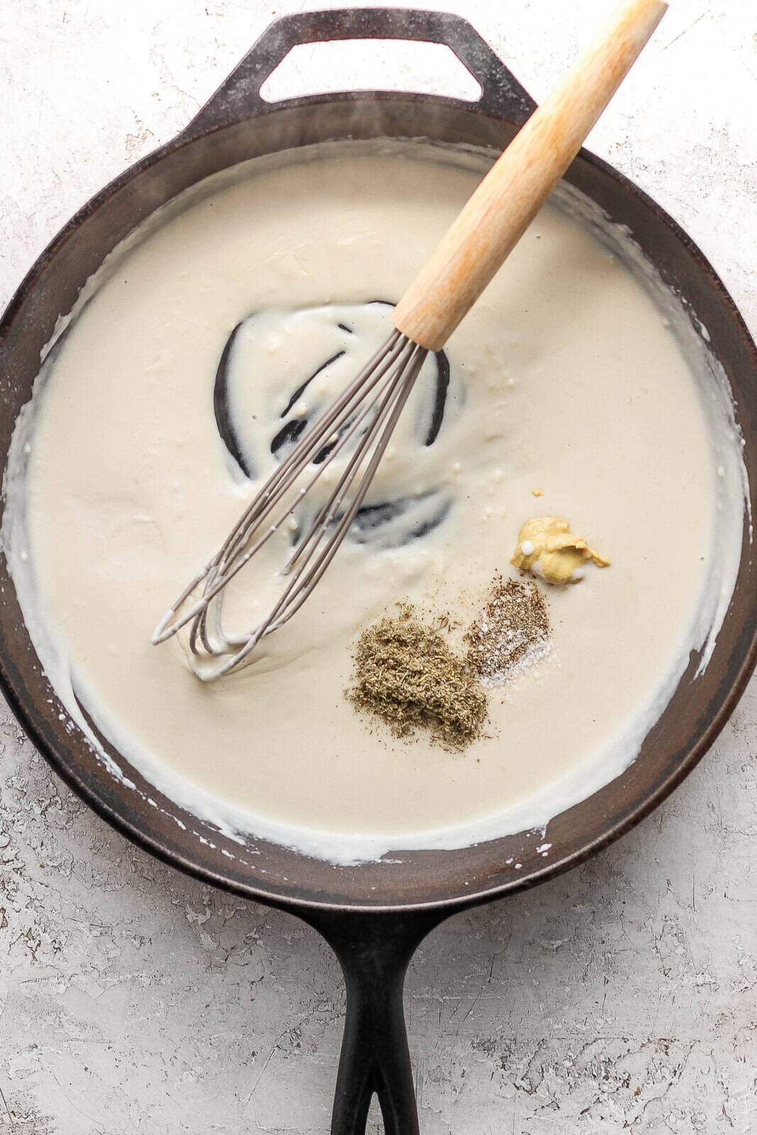 Creamer added to the flour, butter and garlic mixture followed by dijon, dried sage, salt and pepper with a whisk in the skillet.