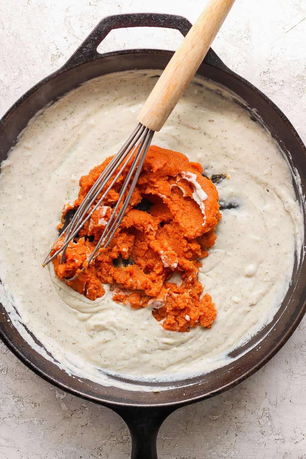 Pumpkin puree added to the roux mixture.