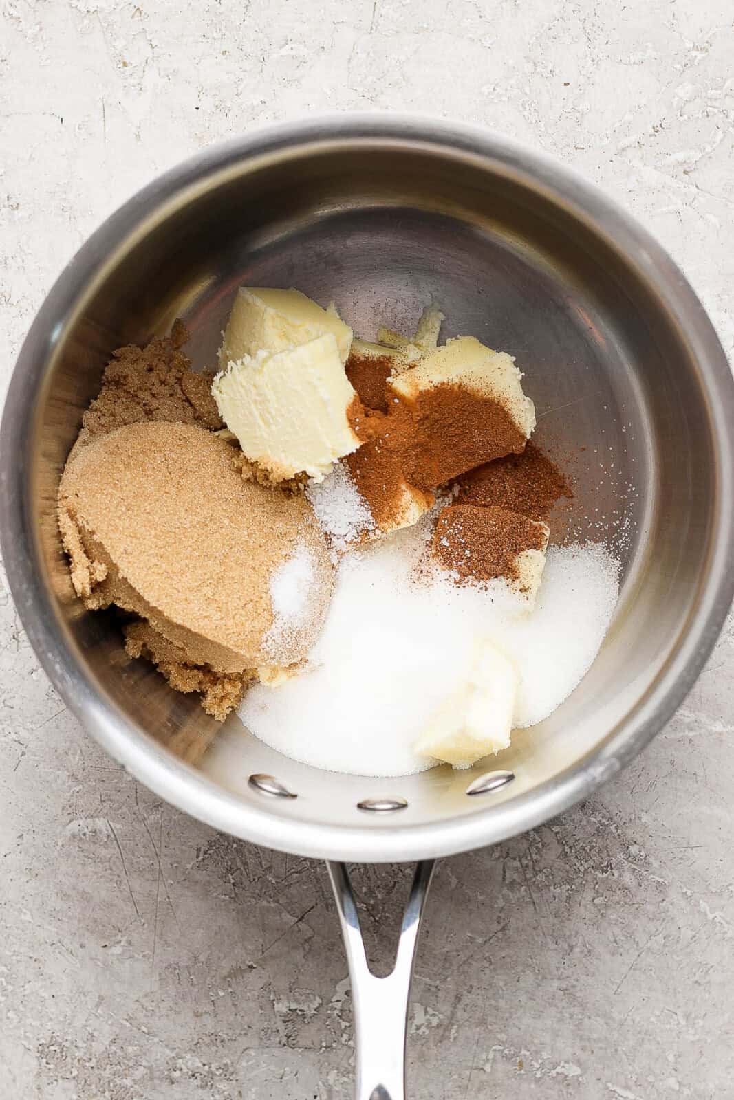 Brown sugar, white sugar, vanilla, butter, nutmeg, and lemon zest, and cinnamon, and bourbon in a sauce pan to make candied yams sauce.