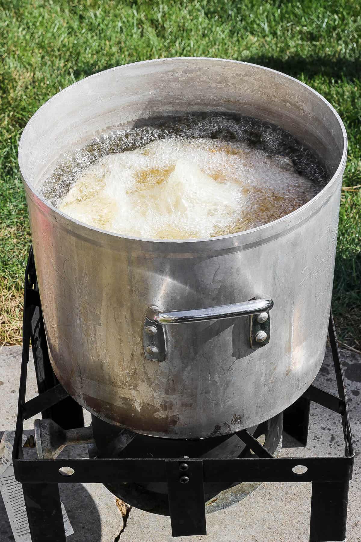 A turkey breast deep frying in hot oil.