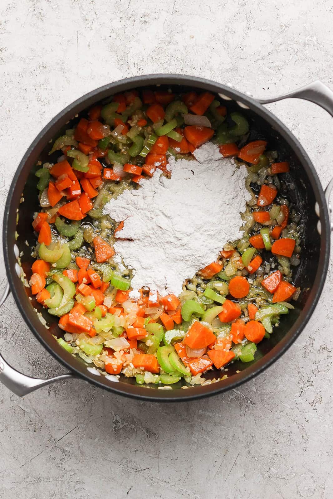 Flour and additional butter added to stock pot to make creamy ham and potato soup.