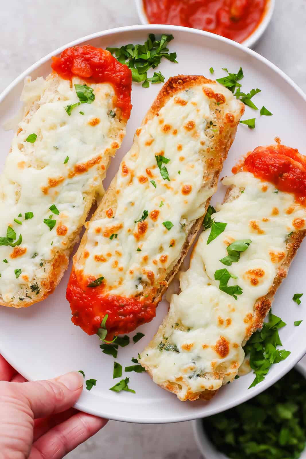 Three hotdog Italian dunkers on a plate.