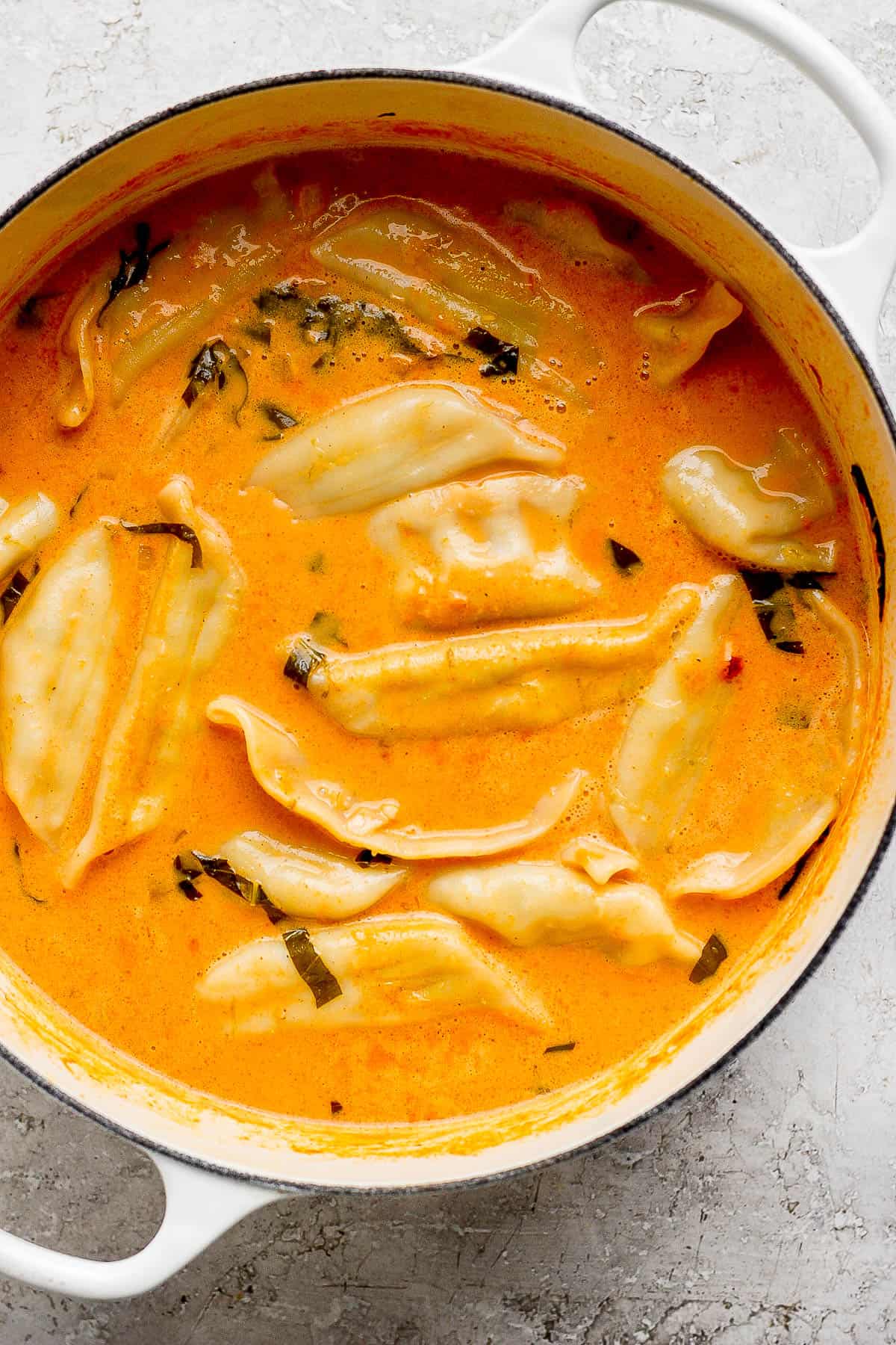 Frozen potstickers added to the pot of soup.