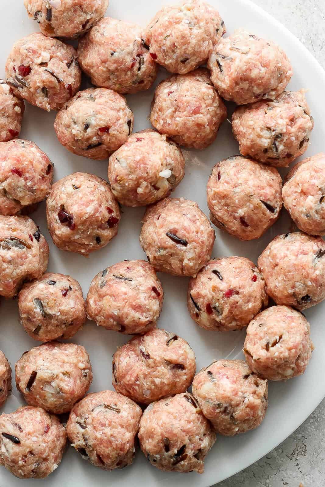Raw Thanksgiving meatballs on a plate.