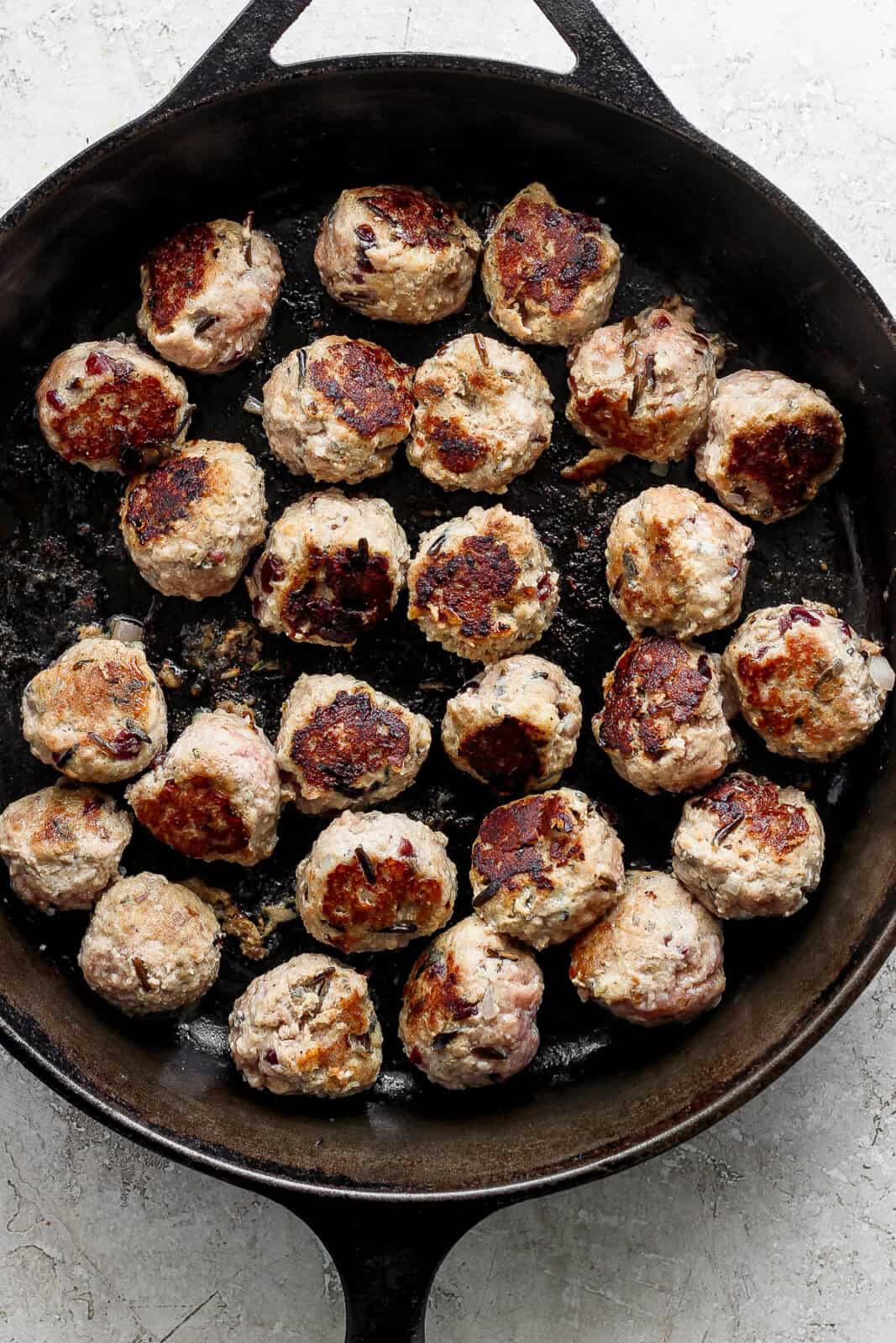 Thanksgiving meatballs seared in a cast iron skillet