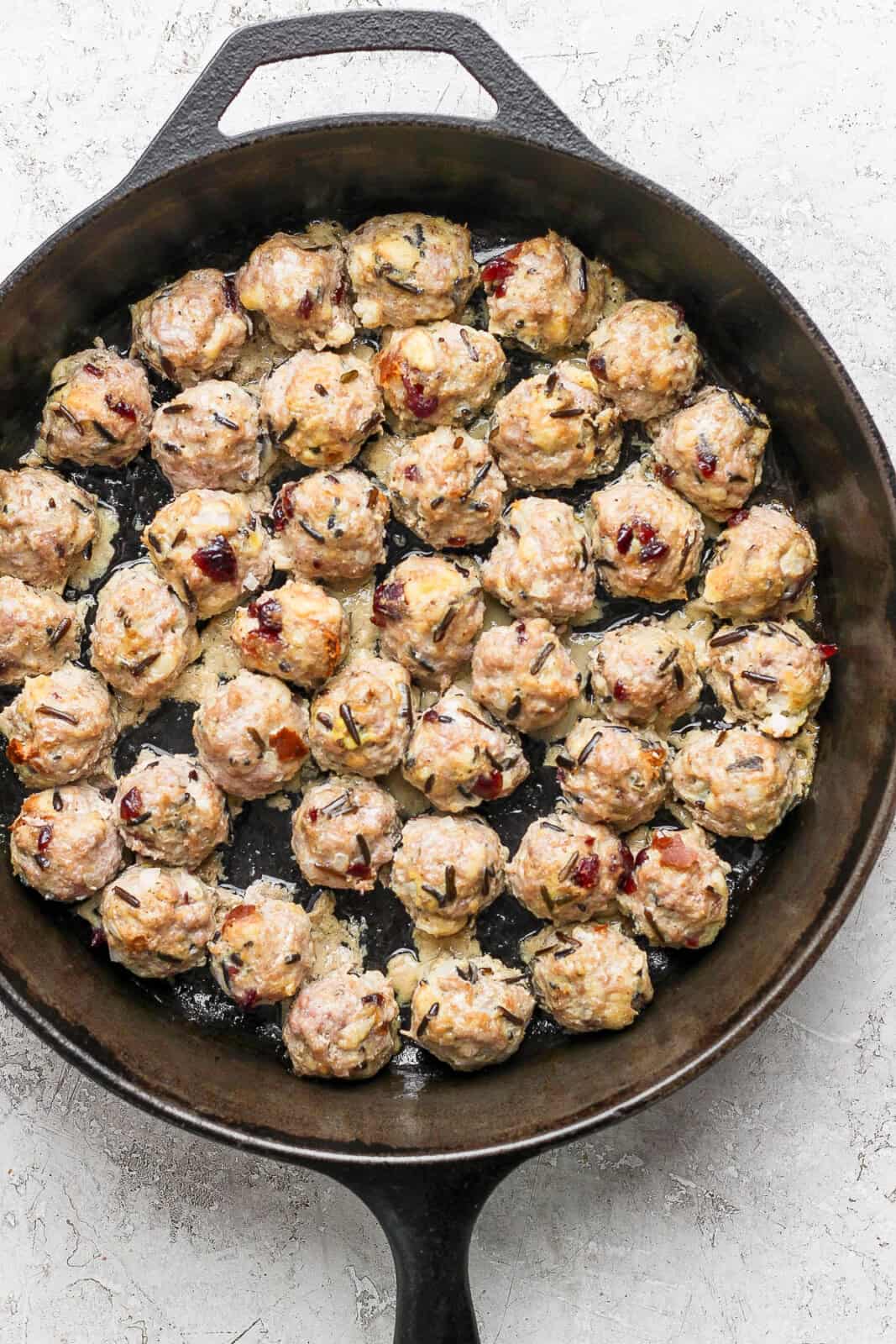 Baked Thanksgiving meatballs in a cast iron skillet.
