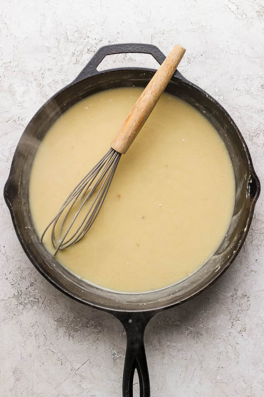 Gravy in cast iron skillet for Thanksgiving meatballs.