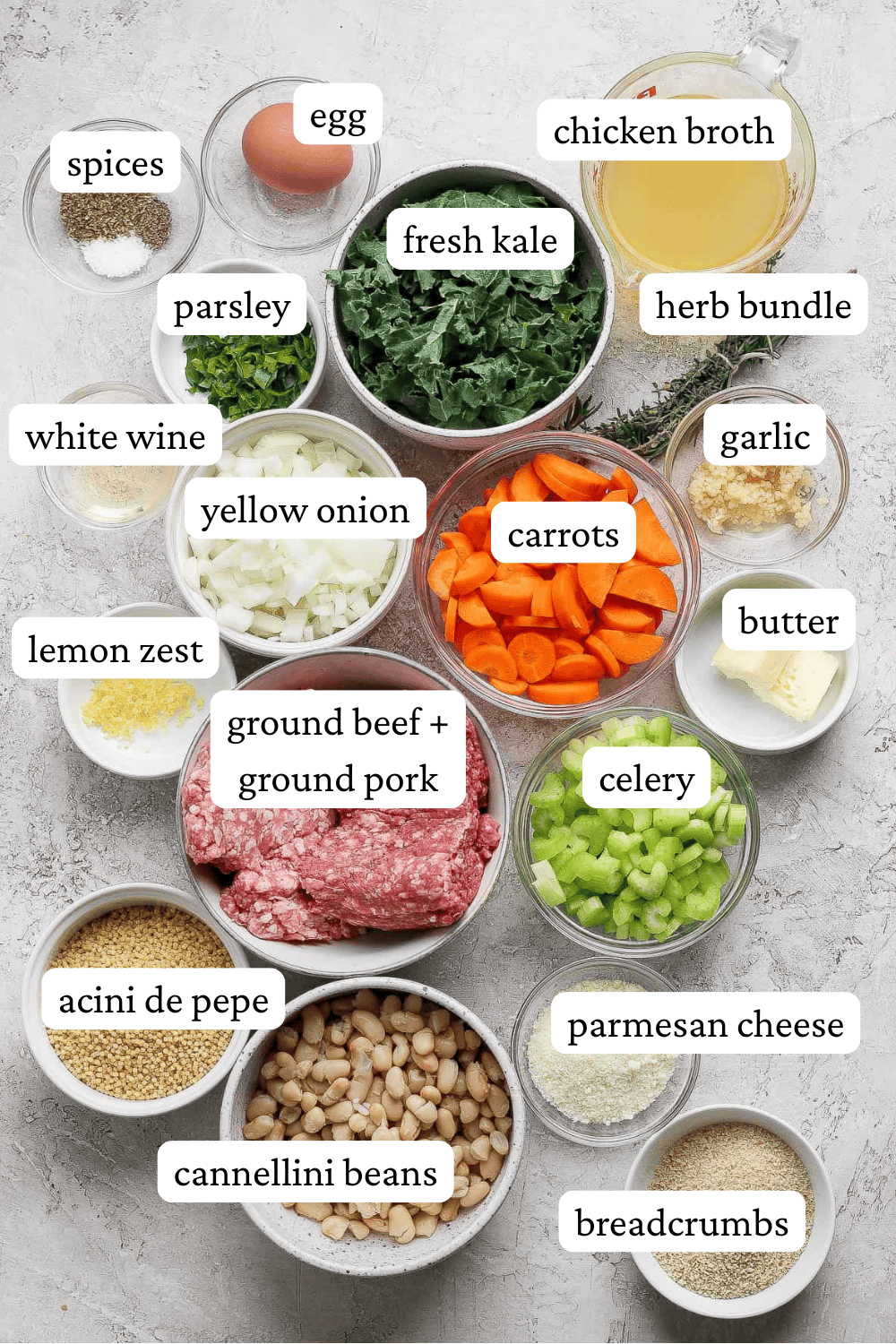 Ingredients for Italian wedding soup in separate bowls with labels.
