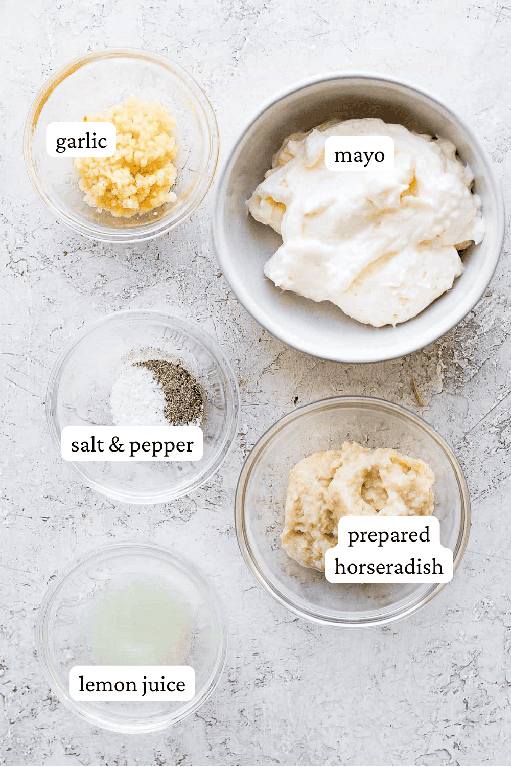 Ingredients for horseradish sauce for prime rib in separate bowls with labels.