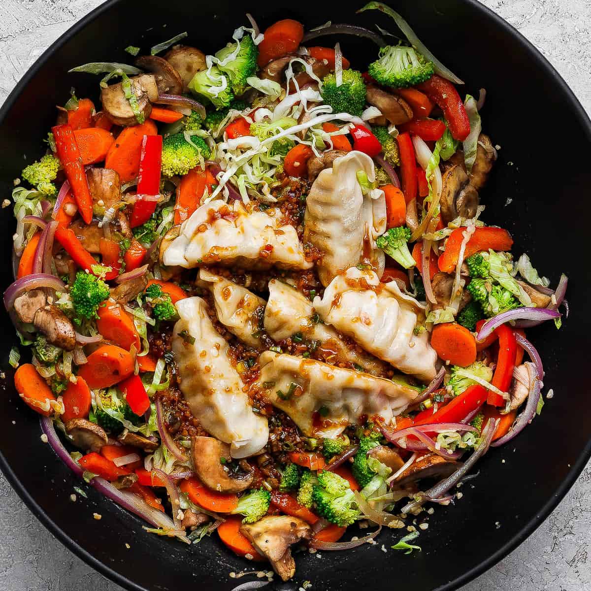 Pot sticker stir fry in a large wok.