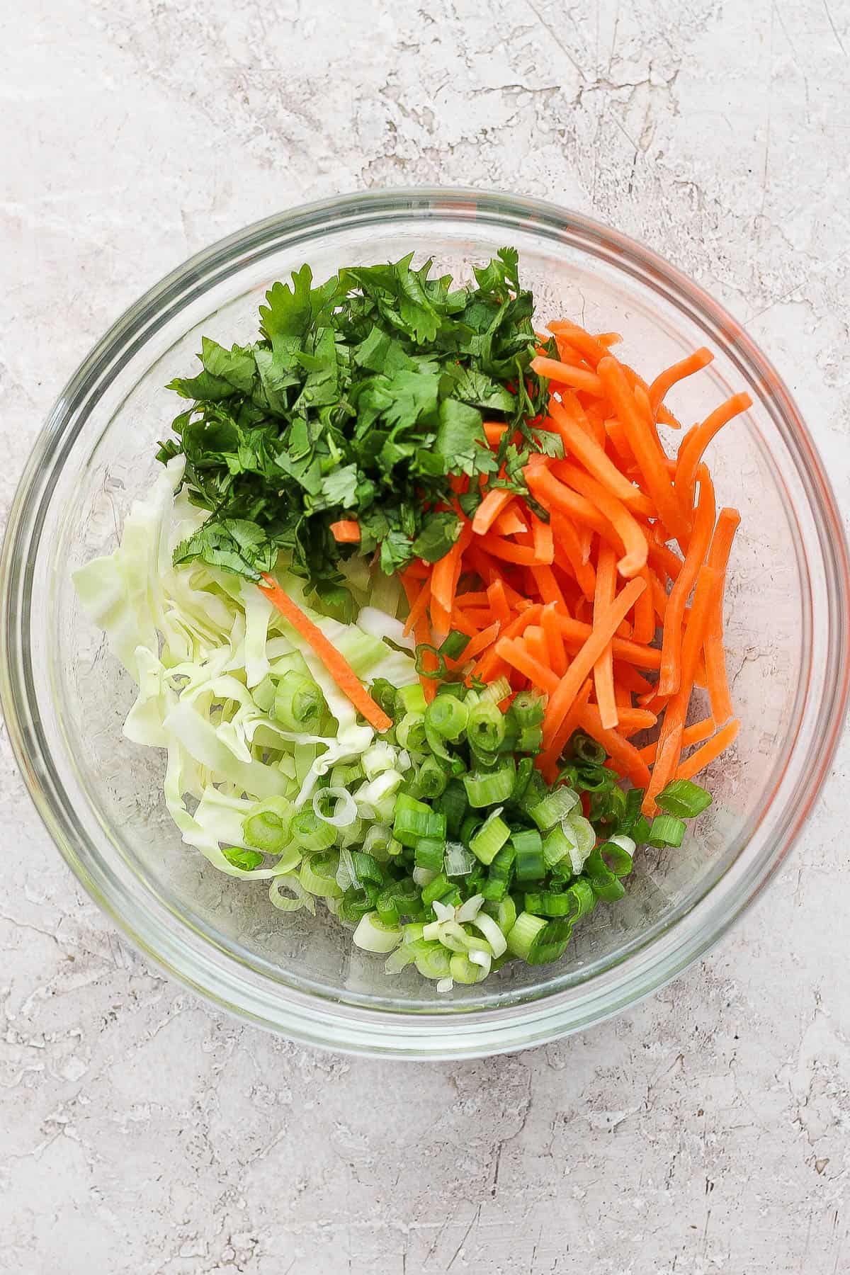 The cabbage slaw mix for smash dumpling tacos in a glass bowl.