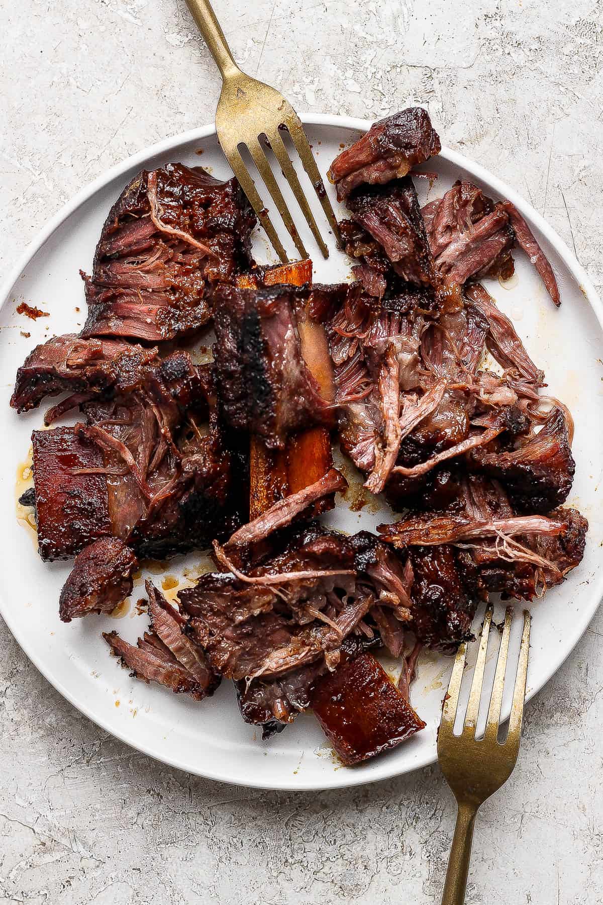 Shredded short rib meat on a plate to make short rib tacos.