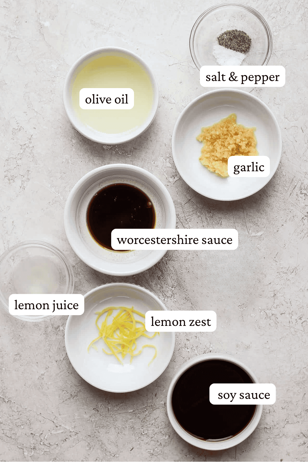 Ingredients for the best chicken marinade in separate bowls with labels.