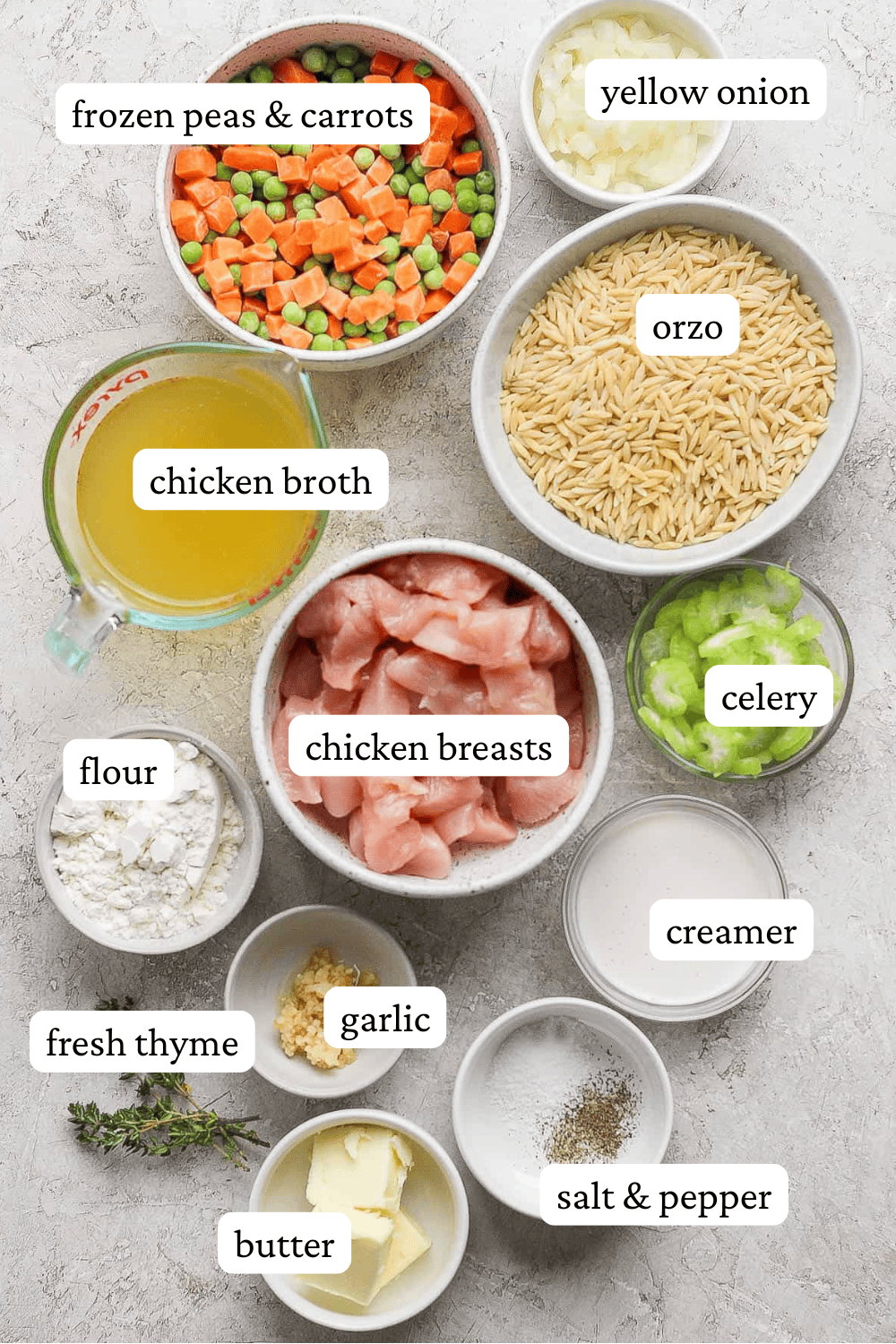 Ingredients for chicken pot pie orzo in separate bowls with labels.