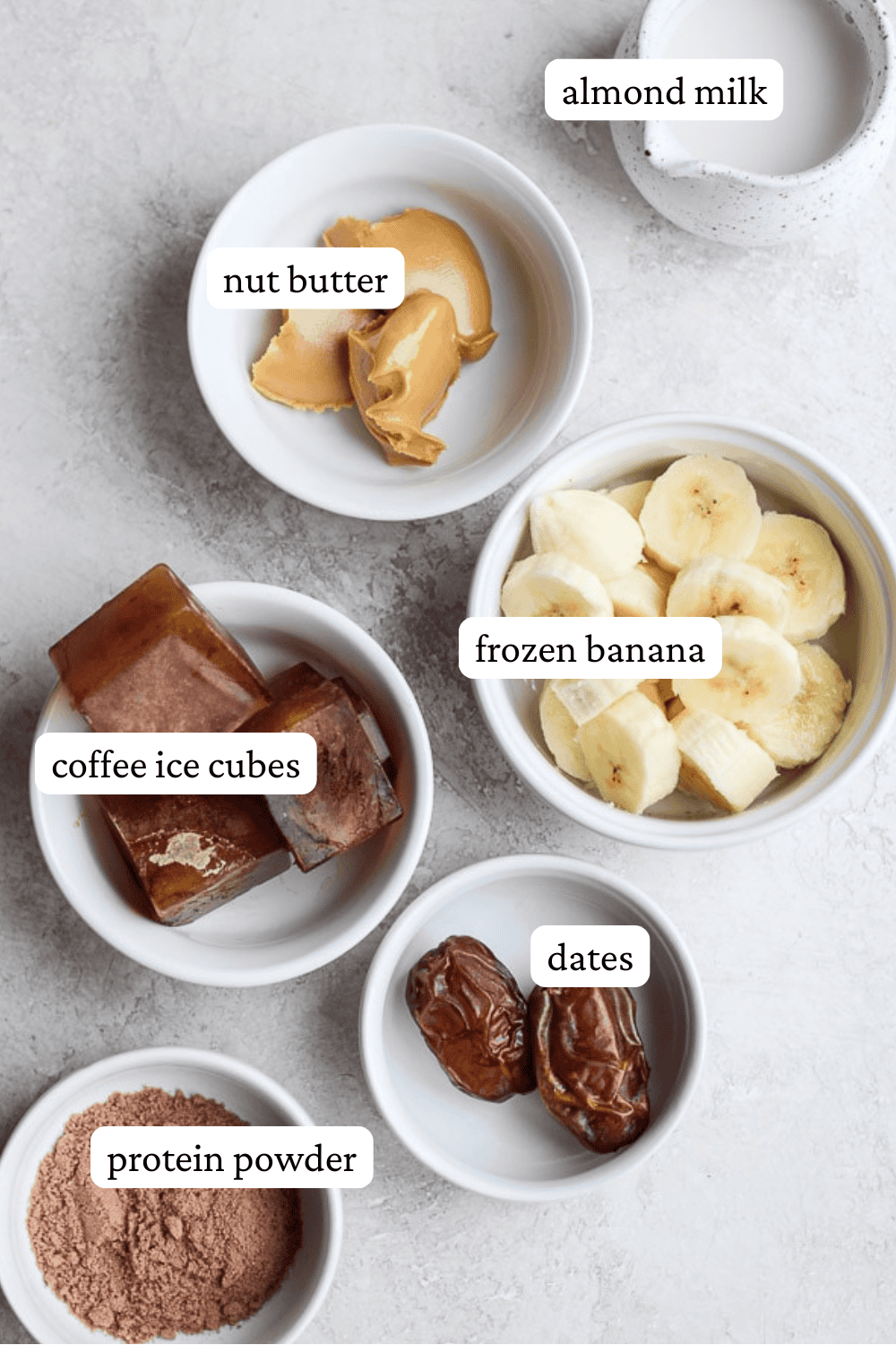 Ingredients for a coffee smoothie in separate bowls with labels.