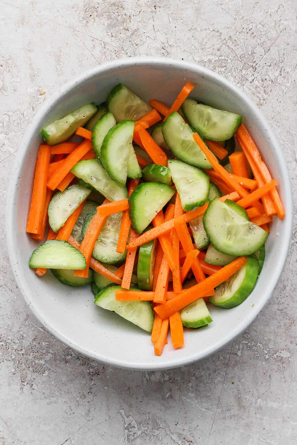 The cucumber and carrot salad mixed in a bowl for Korean bbq bowls.