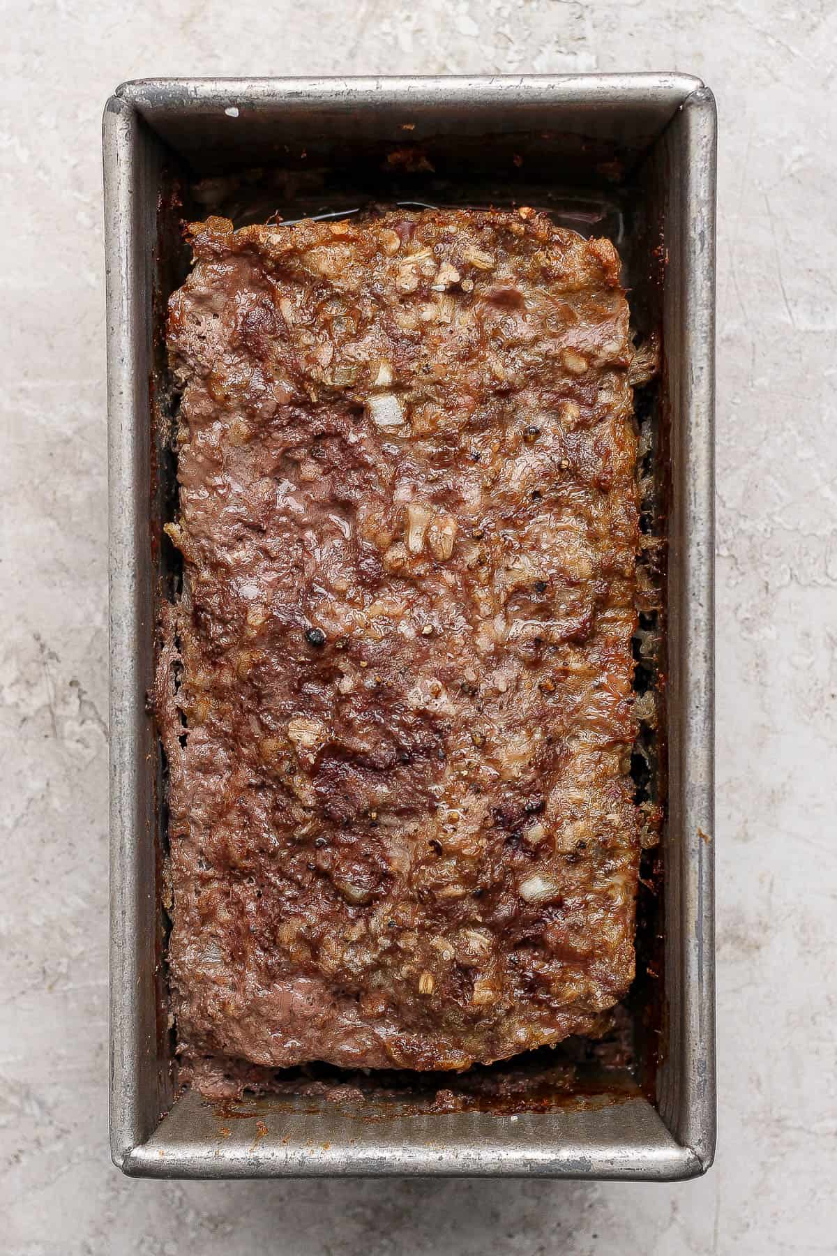 A fully baked healthy meatloaf in a bread pan.