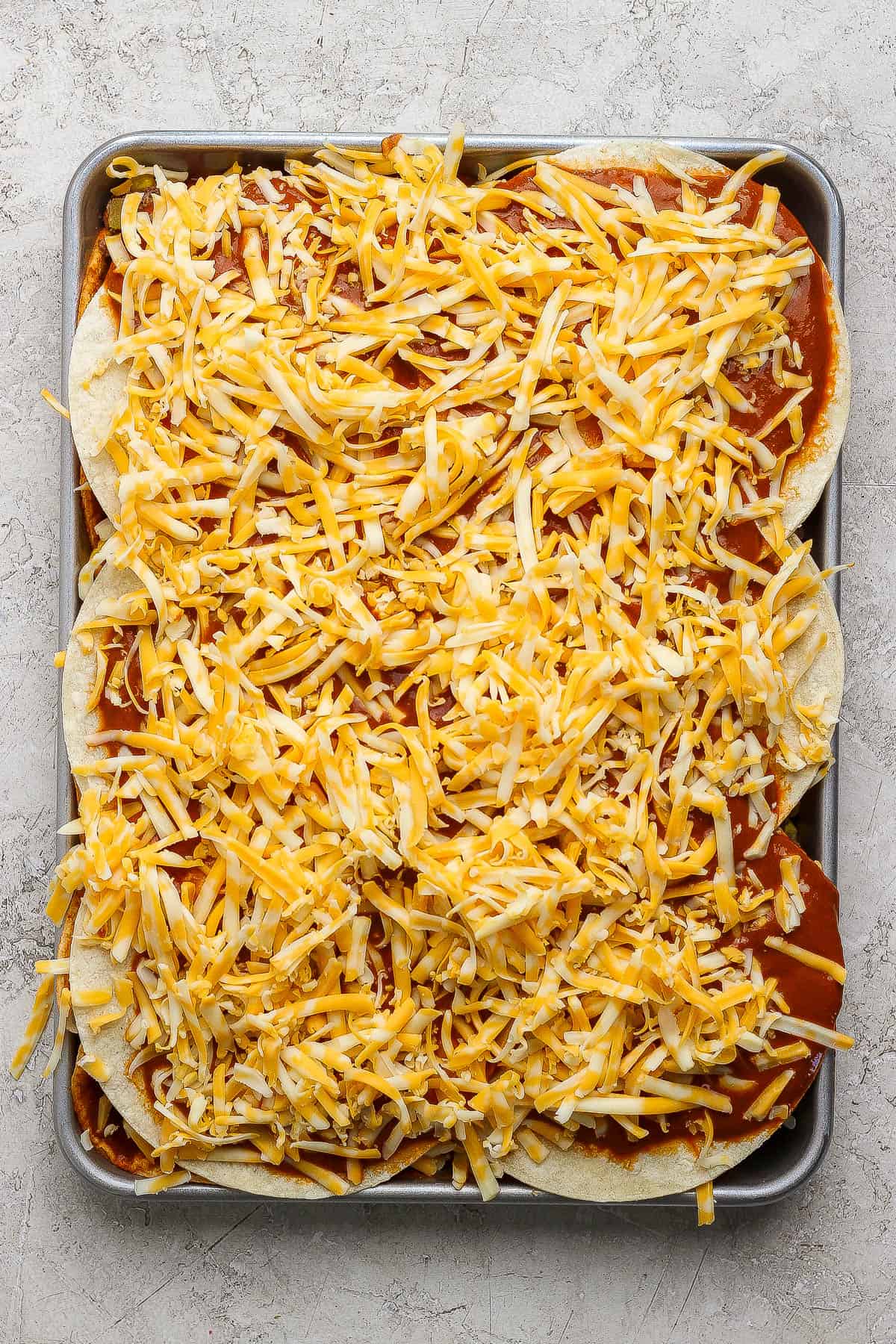 Sheet pan enchiladas fully assembled before baking in the oven.