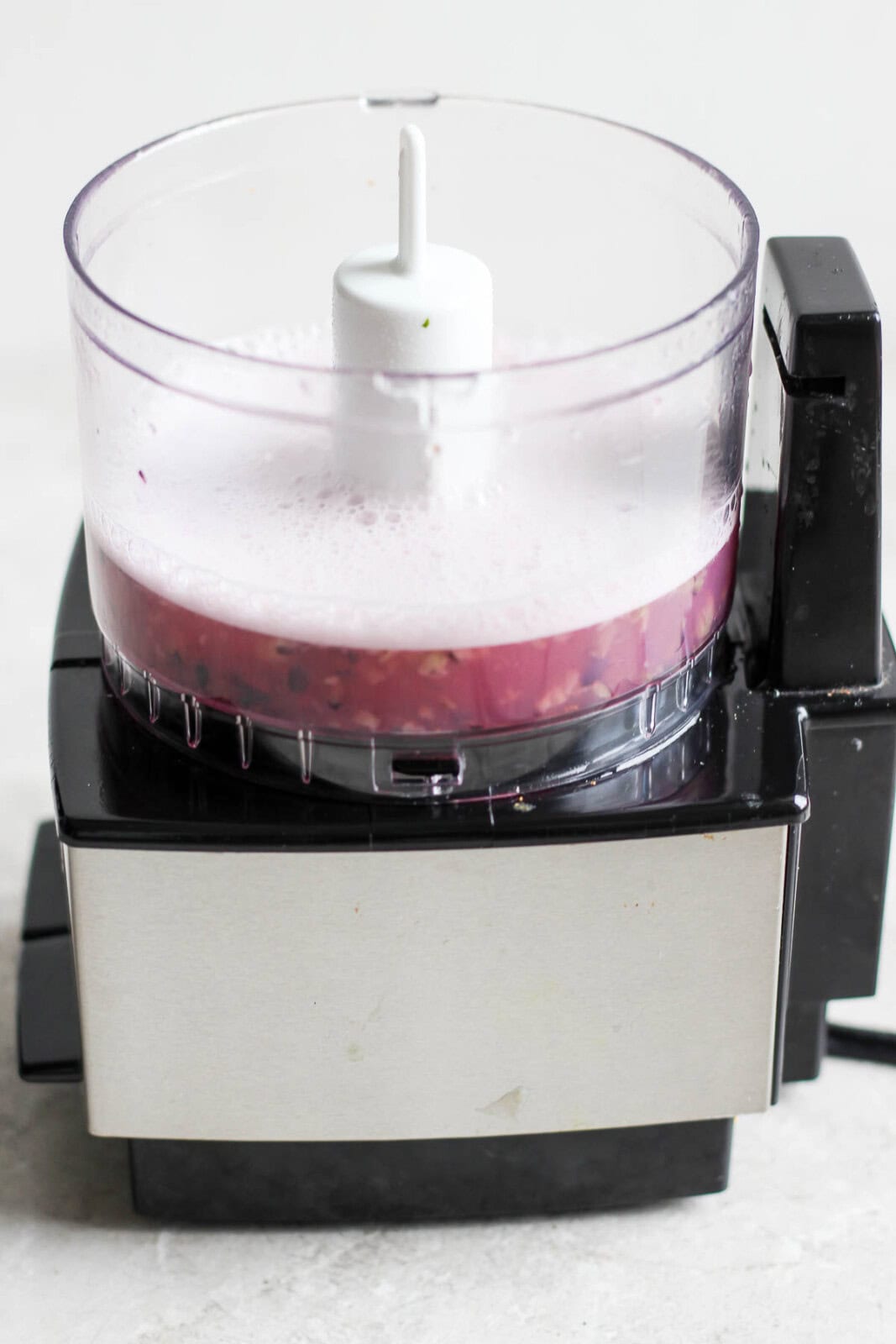 A small blended with blended blueberries, rum, simple syrup, and lime juice to make a blueberry mojito.