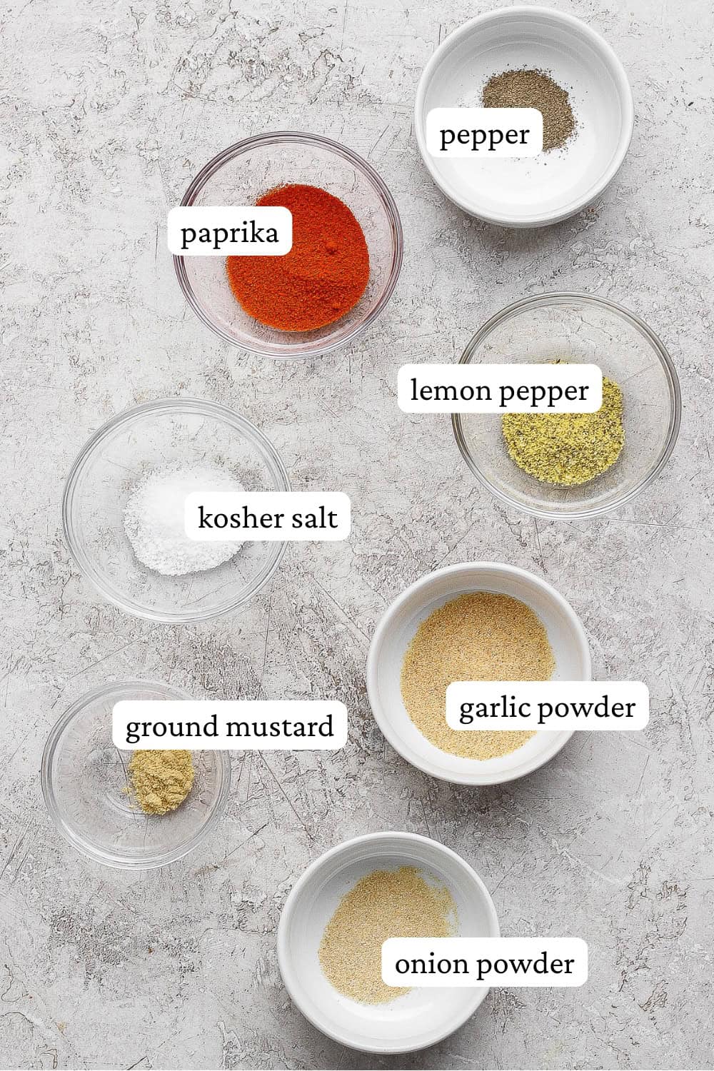 Pork chop seasoning ingredients in separate bowls with labels.