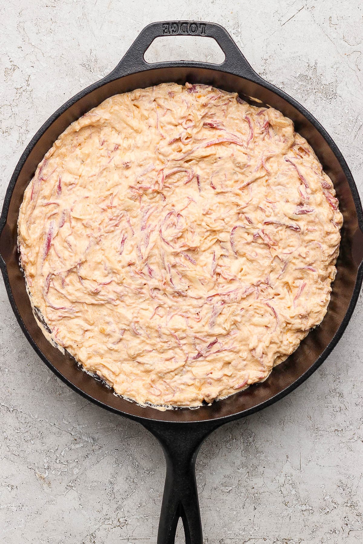Reuben dip mixture in a cast iron skillet.