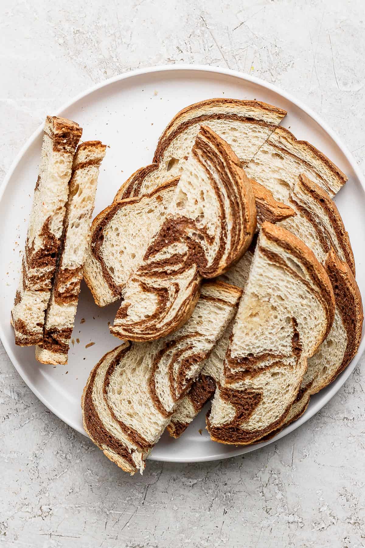 Sliced marble rye bread on a plate.