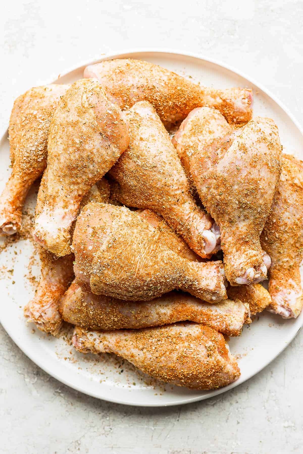 Chicken legs covered with dry rub before going on the smoker.