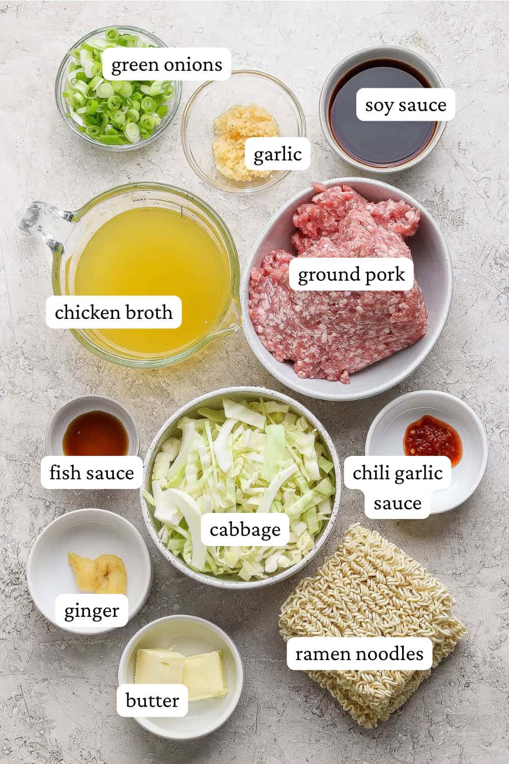 Ingredients for cabbage and noodles in separate bowls with labels.