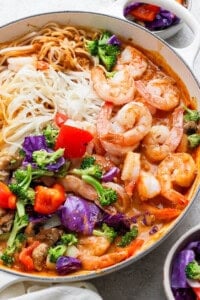Sweet curried shrimp and rice noodles with roasted vegetables added to the pan.