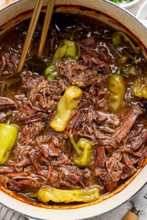 A Dutch Oven filled with cooked Mississippi Pot Roast.