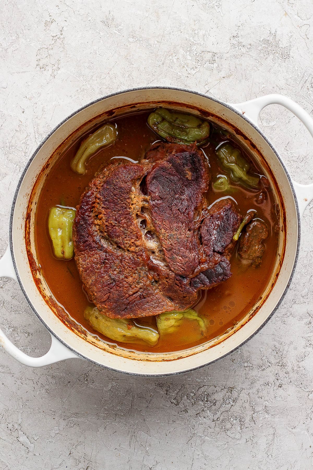 Cooked dutch oven mississippi pot roast before the meat has been shredded.