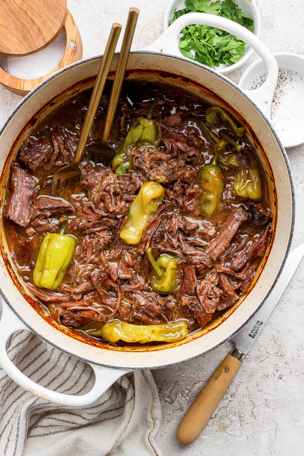 Dutch oven mississippi pot roast in a dutch oven with two forks in the dutch oven. 