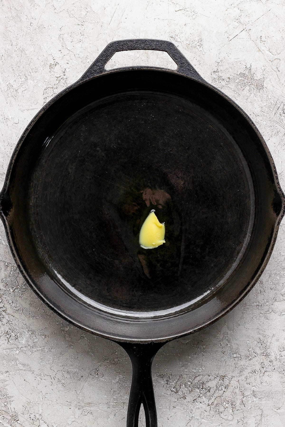 A small amount of ghee in a cast iron skillet.