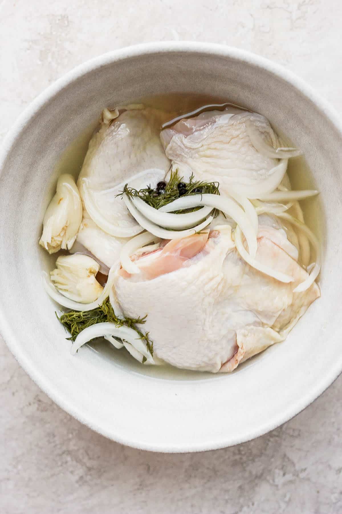 Pickle brine chicken thighs sitting in a bowl before cooking.