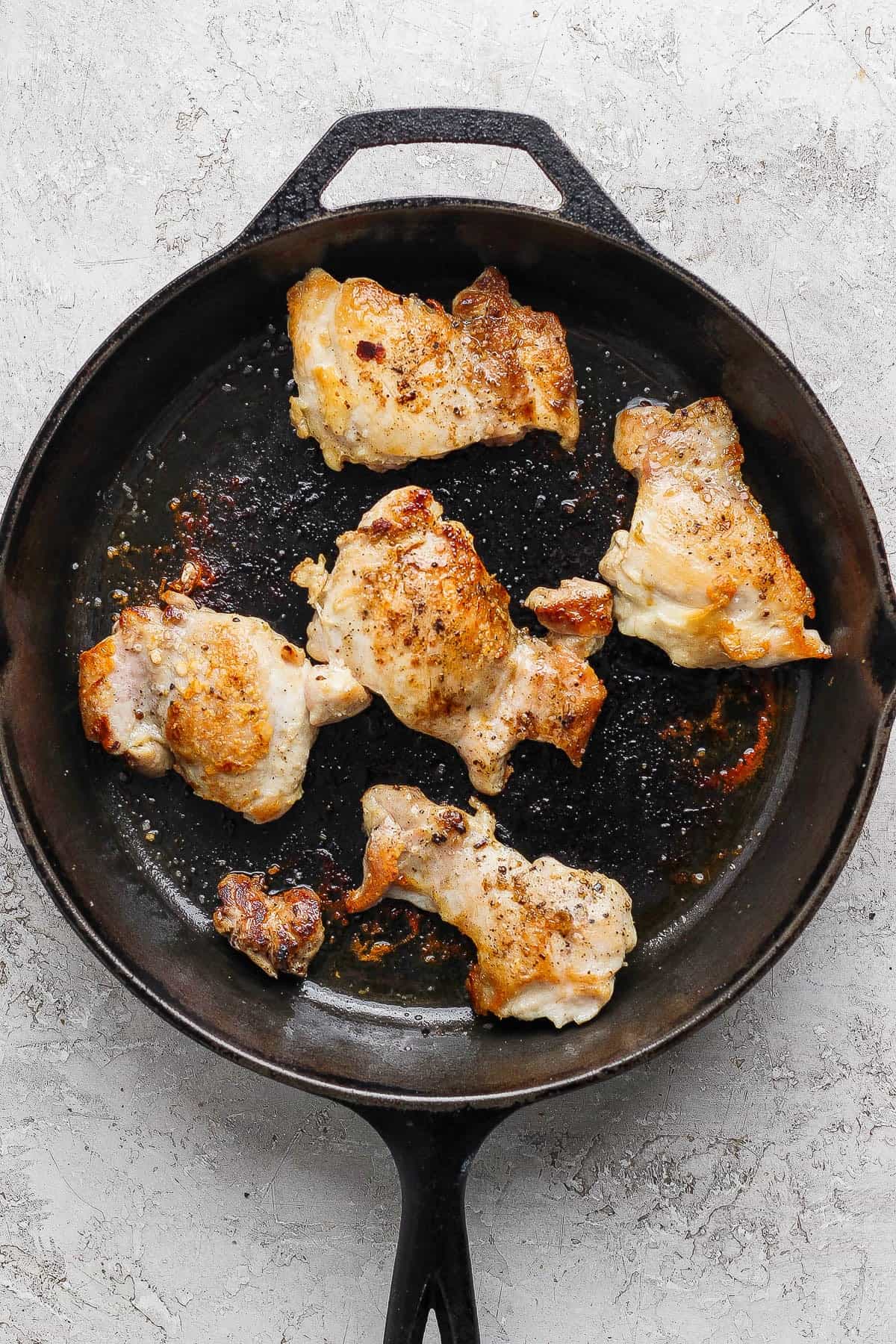 Stove top chicken thighs in a cast iron skillet.