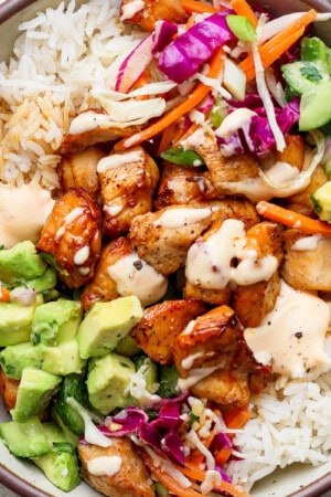 Bang bang chicken rice bowl fully assembled in a large bowl.