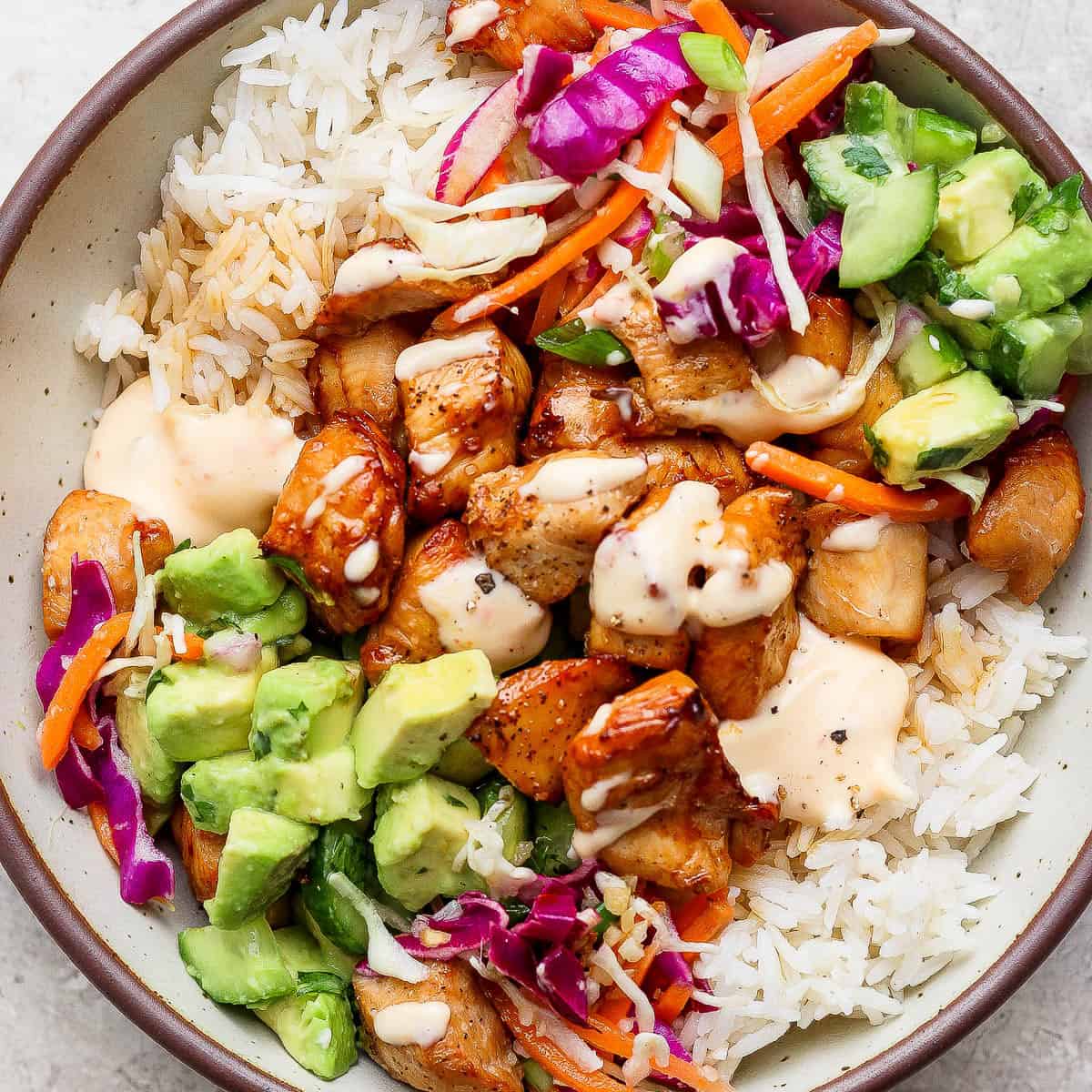 Bang bang chicken rice bowl fully assembled in a large bowl.