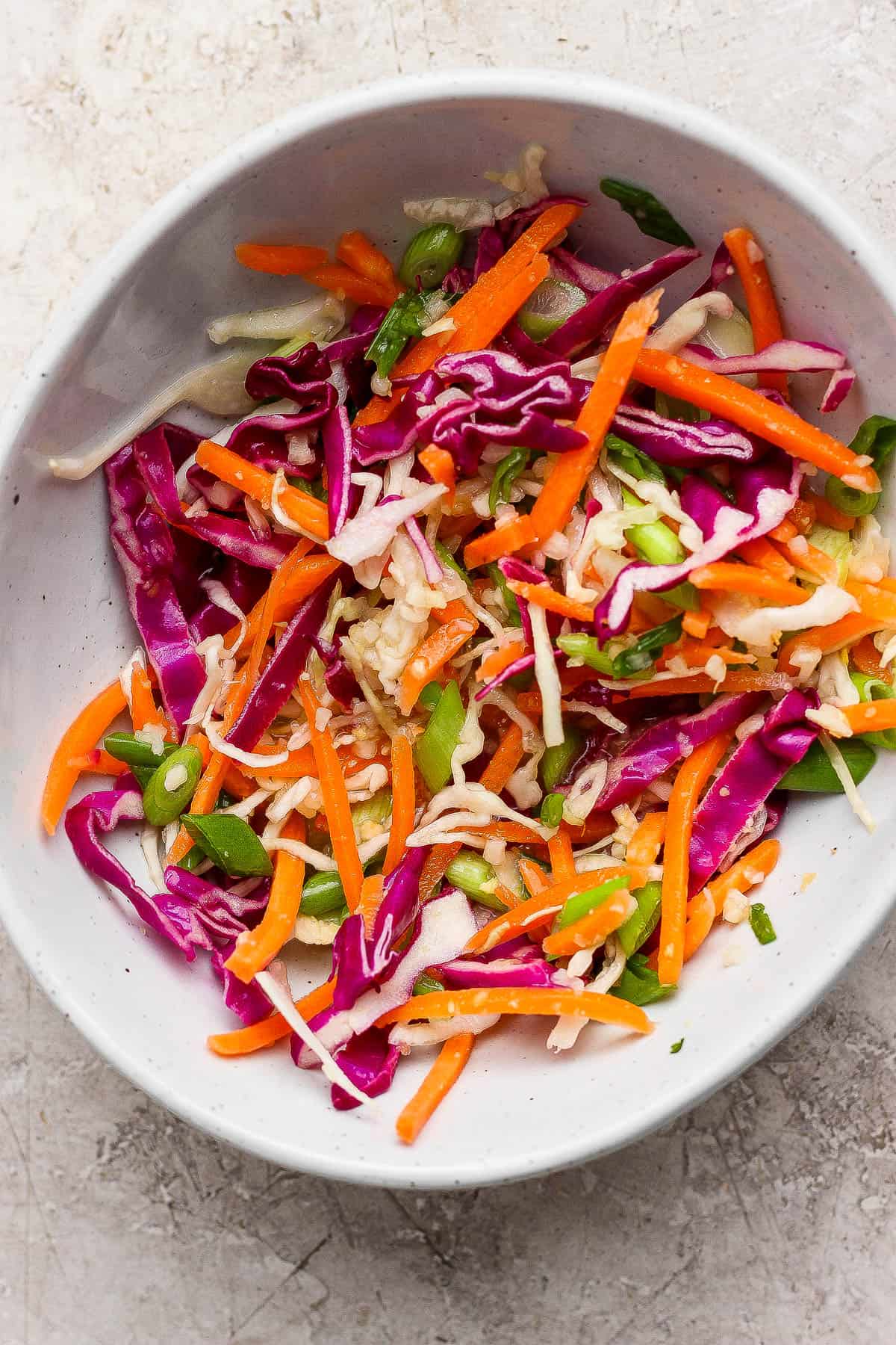 A simple slaw made to go on a bang bang chicken rice bowl.