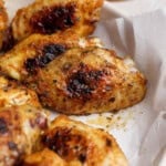 Blackstone chicken wings in a bowl lined with parchment paper.