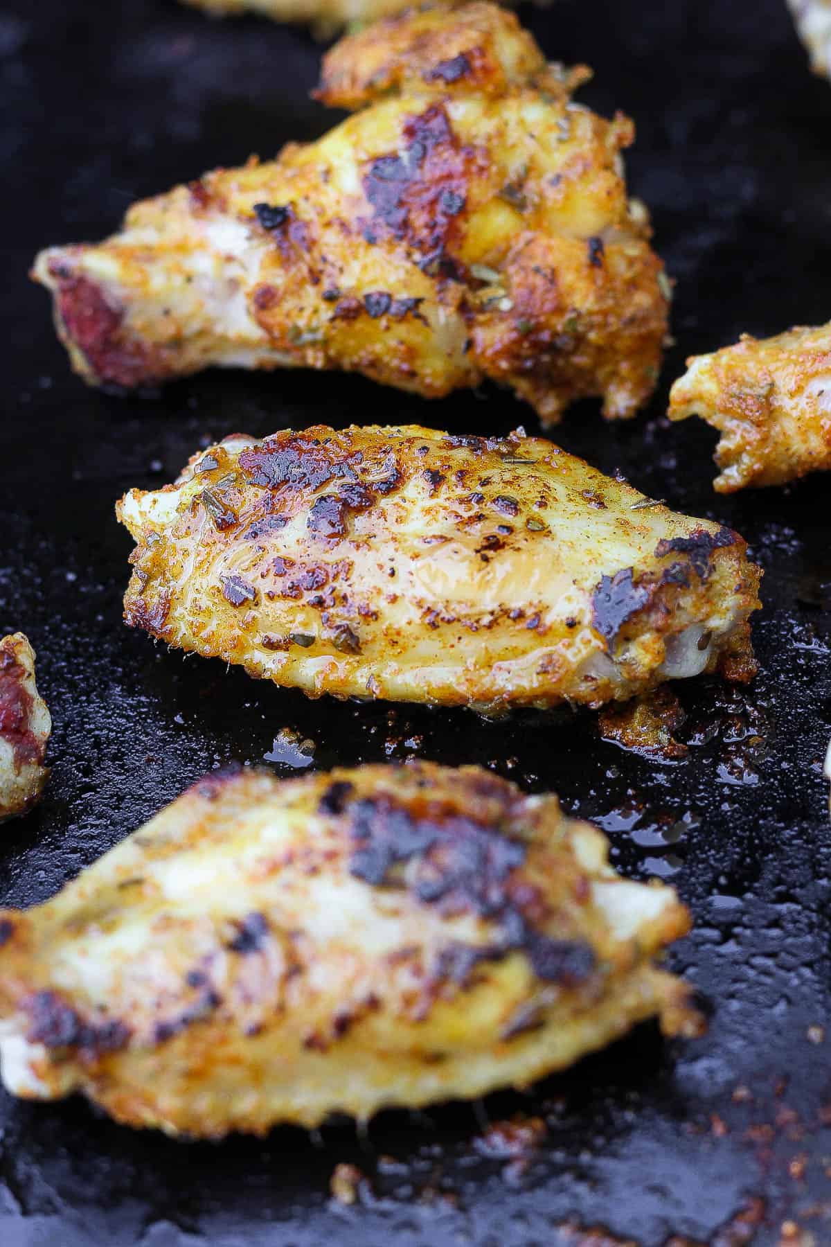 Fully cooked chicken wings on the blackstone.