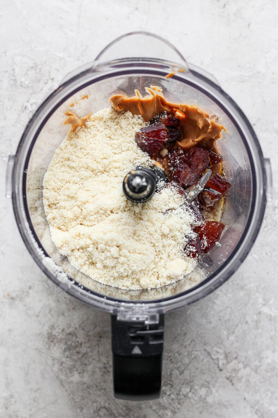 All of the cookie dough bite ingredients in a food processor.