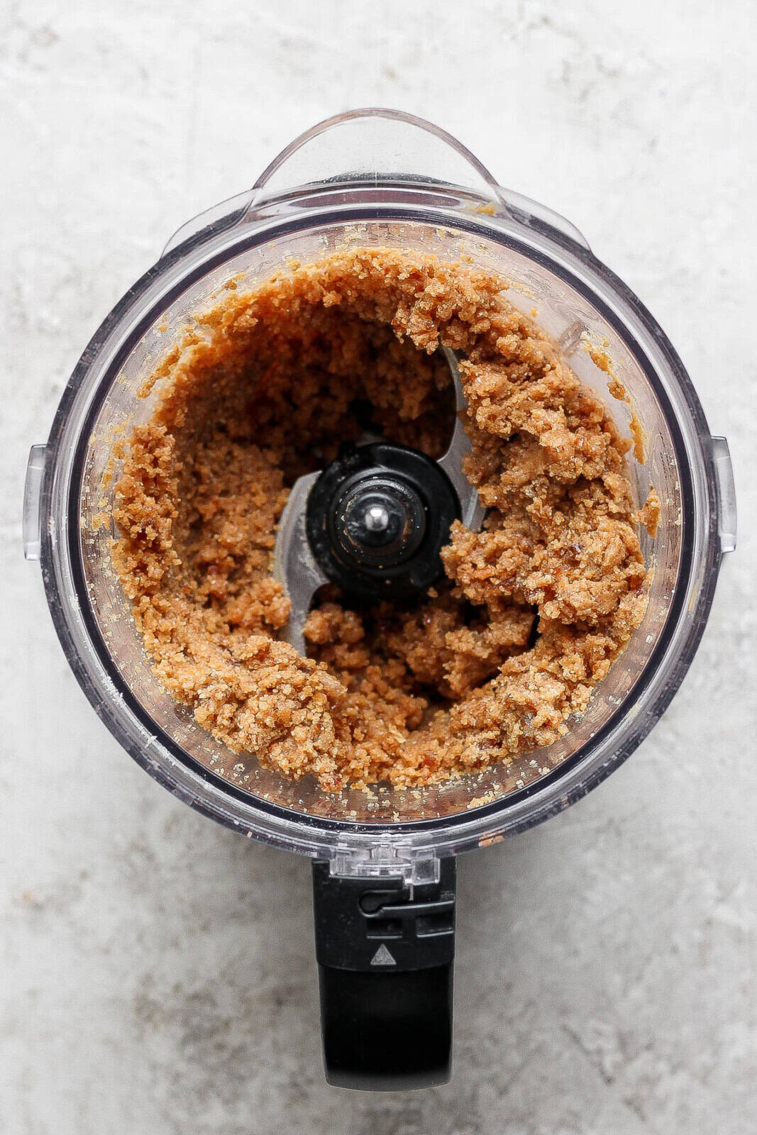 Ingredients for cookie dough bites blended together in a food processor. 