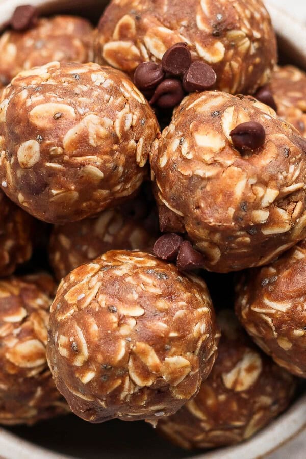 Several chocolate peanut butter energy balls in a bowl.