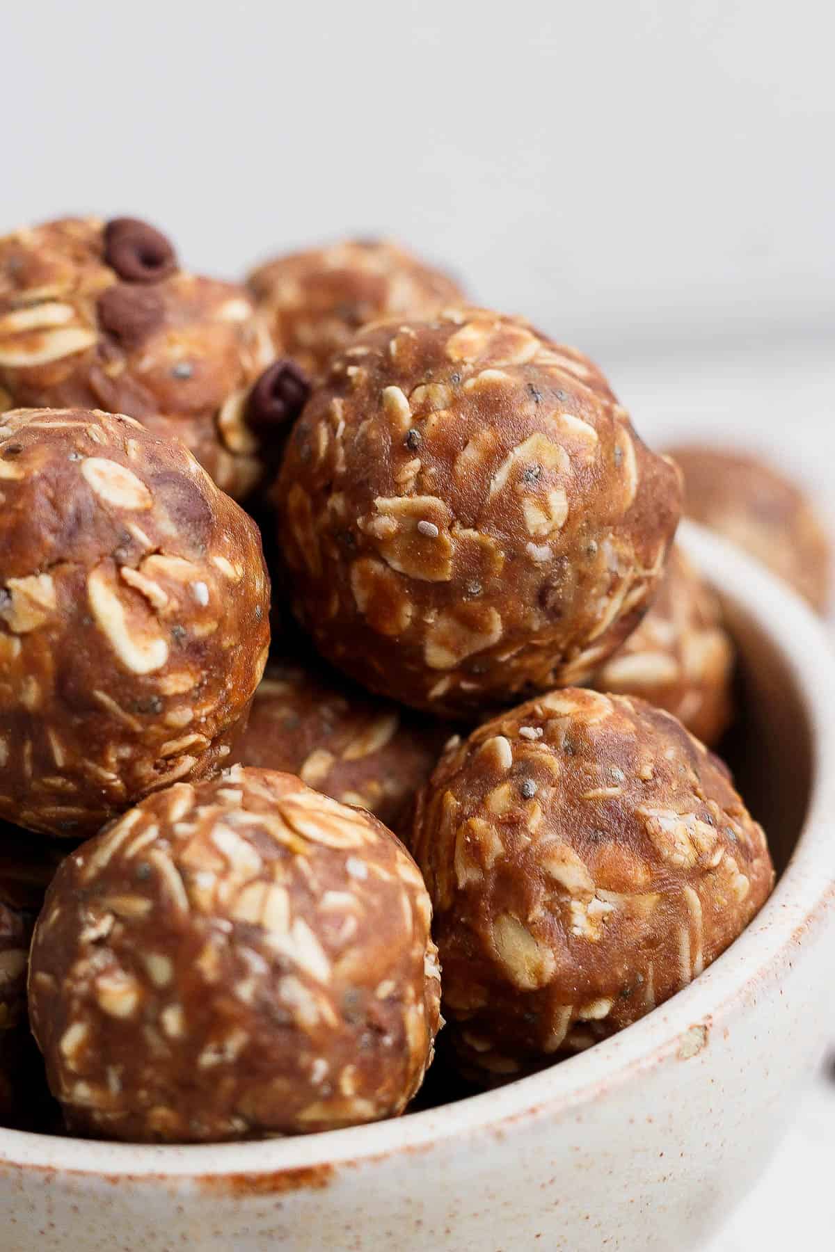 Chocolate peanut butter energy balls in a stone bowl.