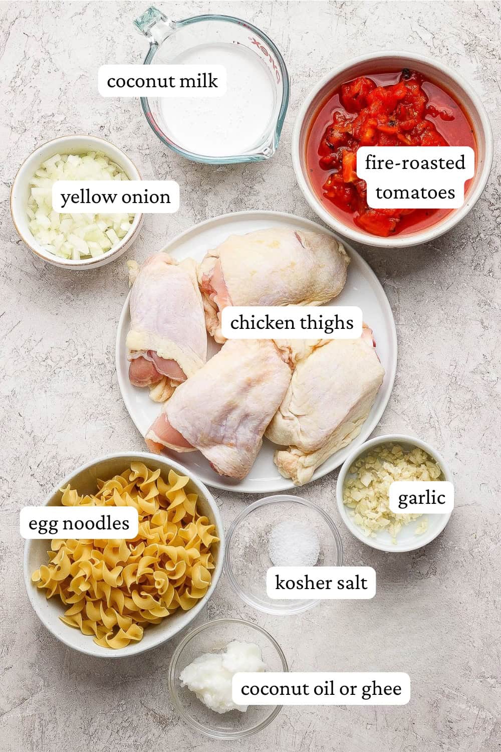 Ingredients for creamy tomato chicken thighs in separate bowls with labels.