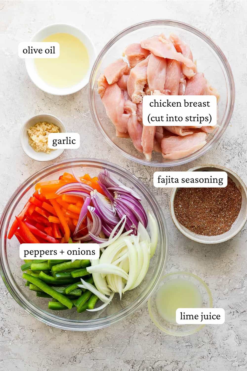 Ingredients for grilled chicken fajitas in separate bowls with labels.