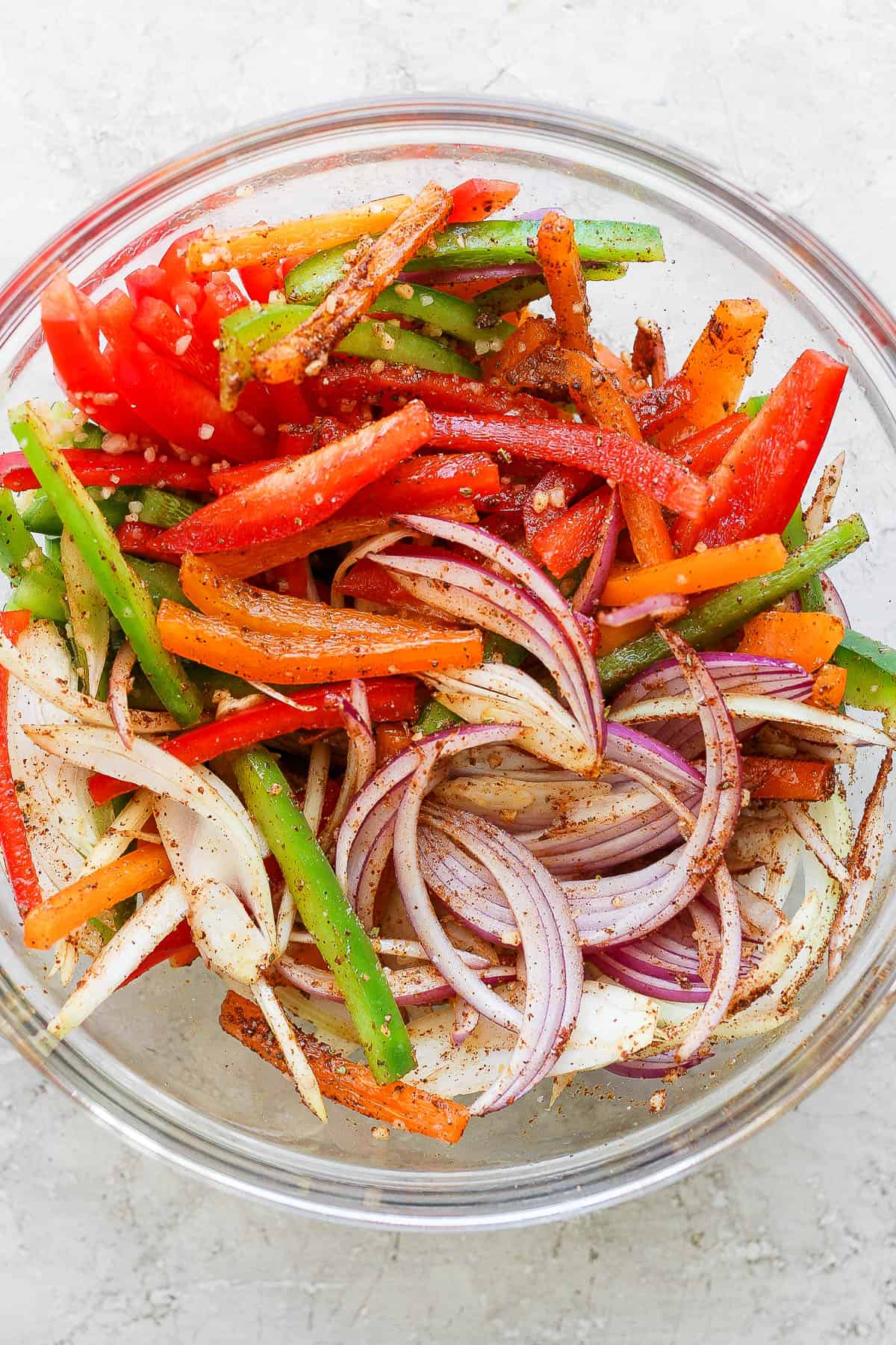 Fajita veggies and onion tossed with fajita seasoning before being grilled.