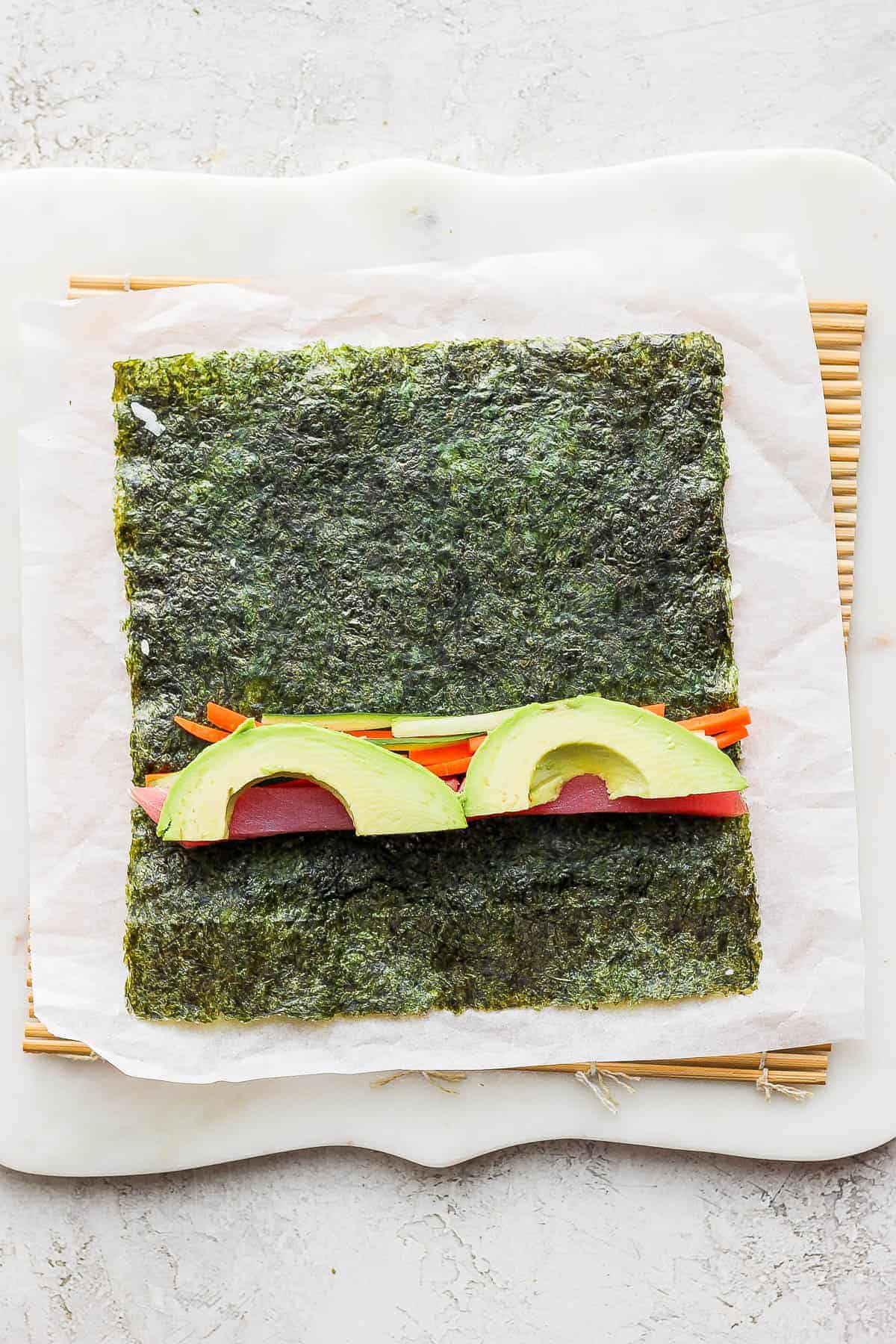 Fillings added to the middle of a nori sheet to make a homemade inside out roll.
