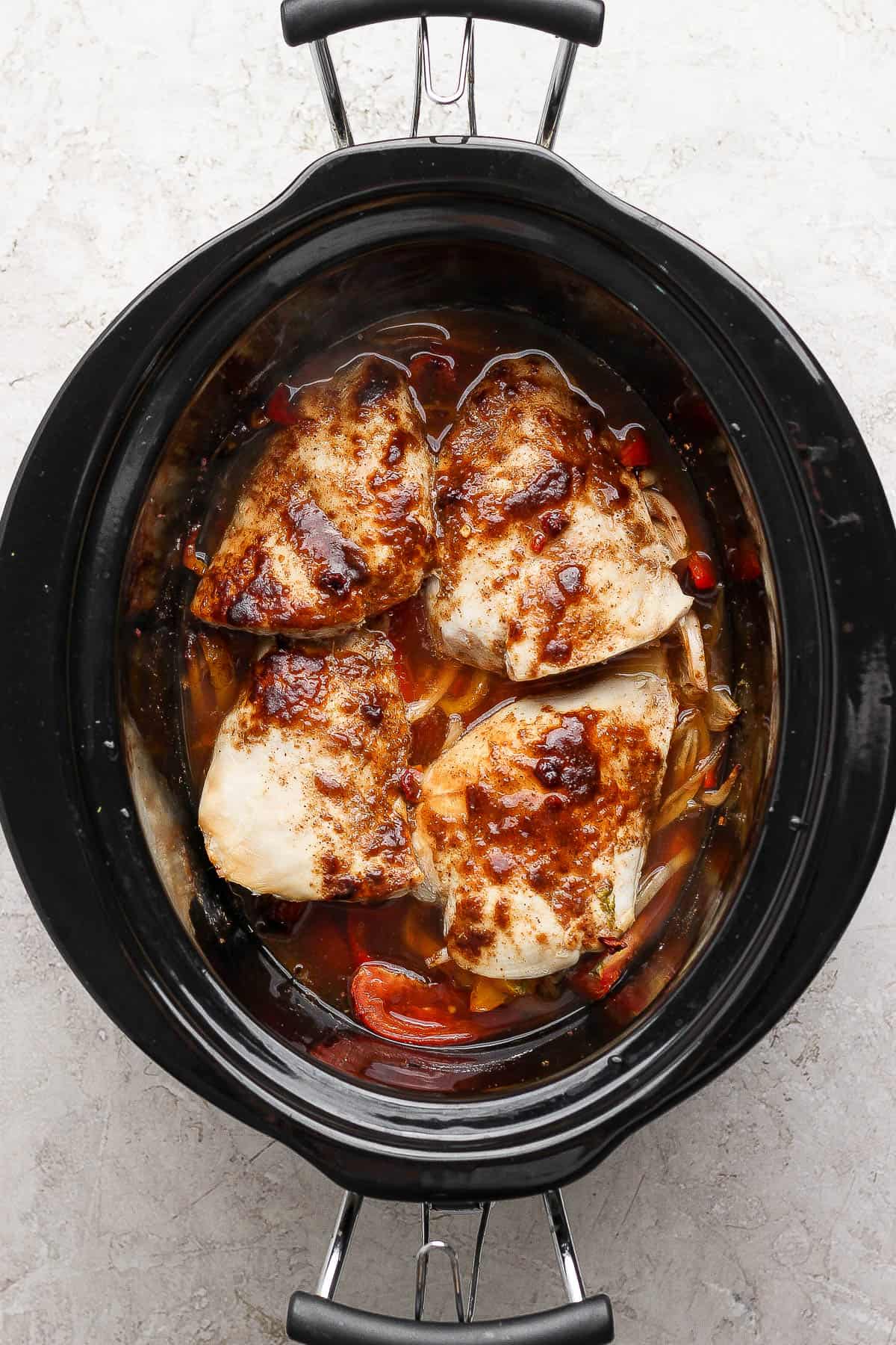 Slow cooker chicken fajitas in the crockpot after cooking.